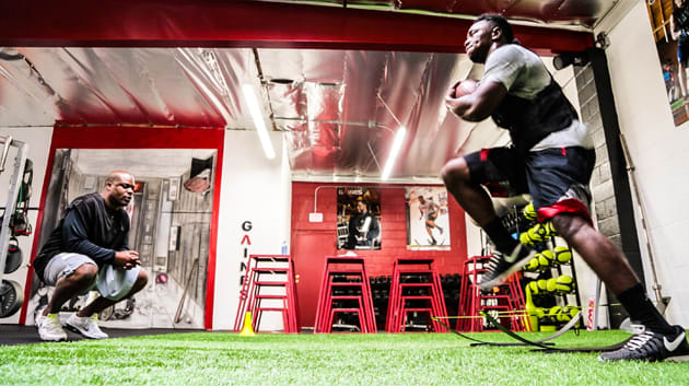 Panthers running back Kenjon Barner runs speed drills under Gaines' watchful eye.